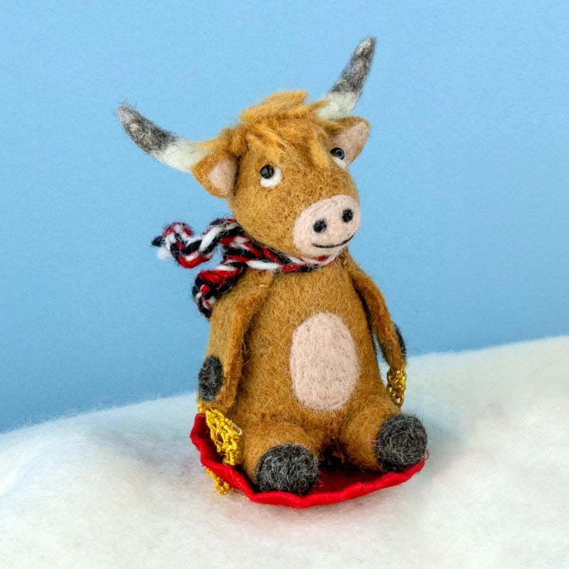 Sledding Highland Cow Wool Ornament