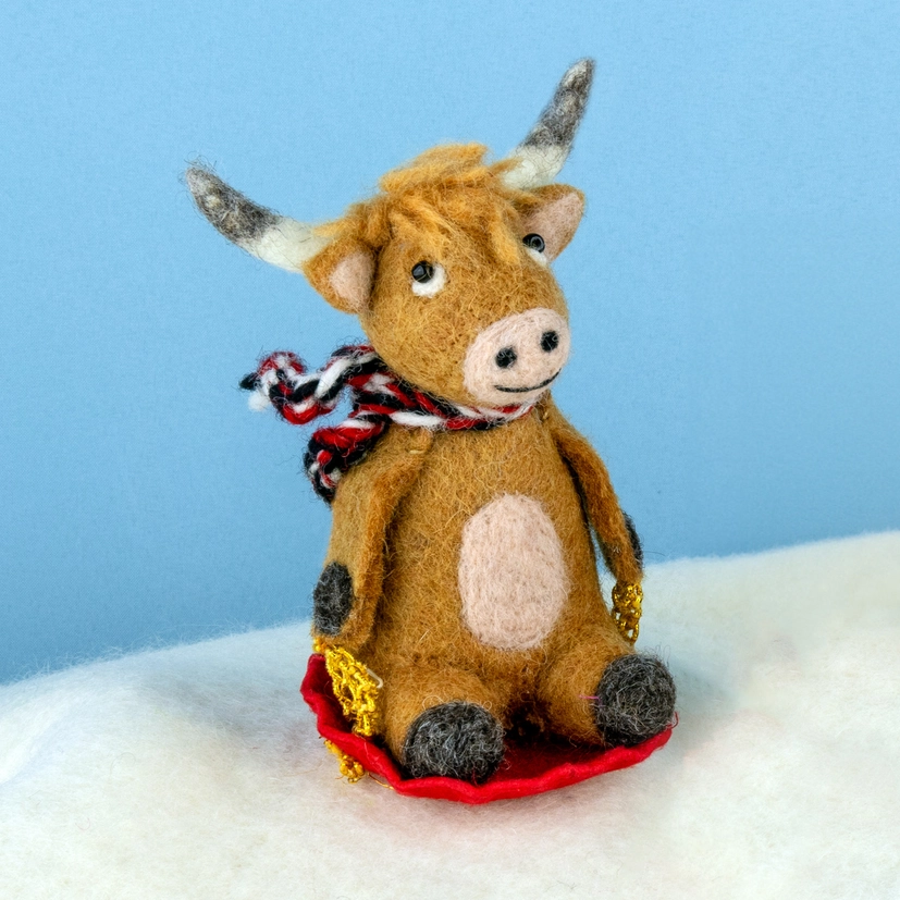 Sledding Highland Cow Wool Ornament